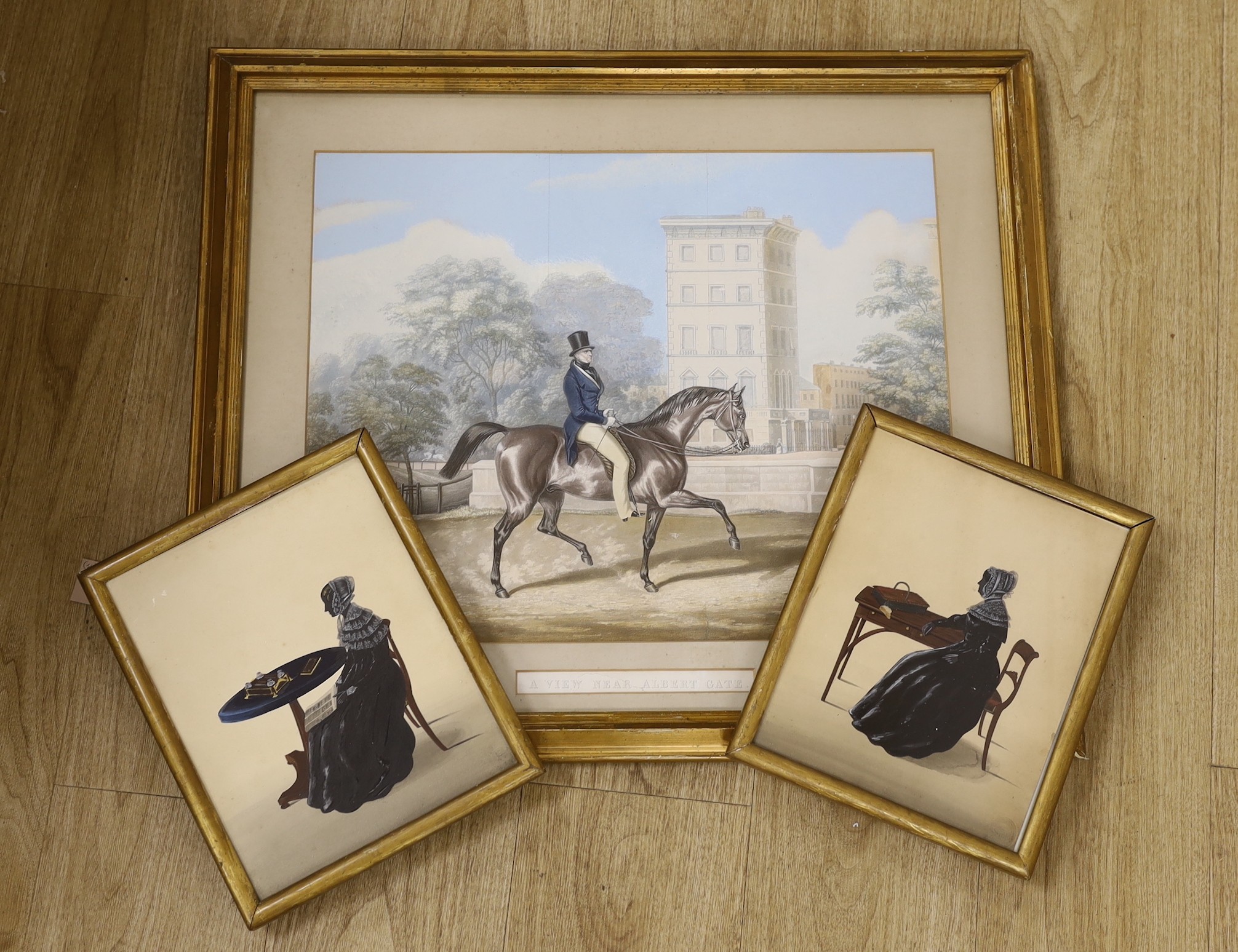 19th century English School, two painted silhouettes, Full length profiles of lady's seated at a table, indistinct Studio stamps, 27 x 21cm and a coloured lithograph, A View Near Albert Gate, 42 x 52cm